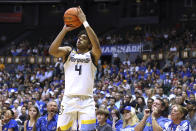 Marquette guard Stevie Mitchell shoots a 3-pointer against Kansas during the first half of an NCAA college basketball game Tuesday, Nov. 21, 2023, in Honolulu. (AP Photo/Marco Garcia)