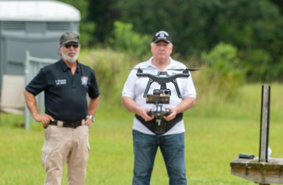 Drone instructor Joseph Dorando and student Pat Rushing take flight Monday at the Escambia RC Model Park. Rushing is taking part in a Wounded Eagle UAS program that teaches wounded and disabled veterans how to operate and repair drones, as well as earn an FAA or commercial drone driver's license.