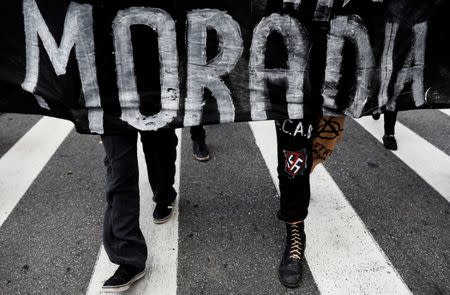 Anarchists hold a banner that reads "Housing" during a protest against President Michel Temers proposed economic reforms in Sao Paulo, Brazil, June 30, 2017. REUTERS/Nacho Doce