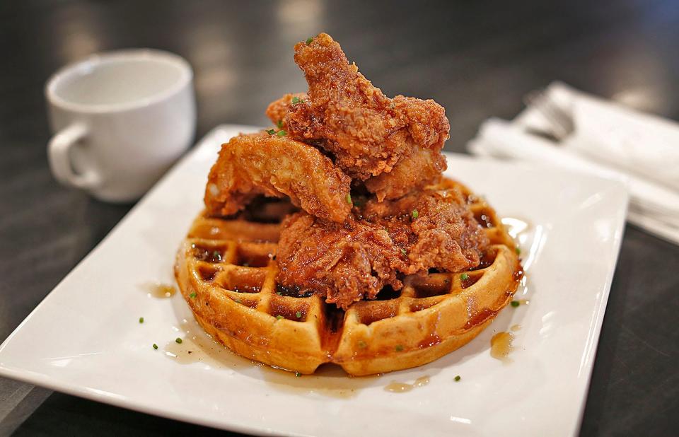 A breakfast feast of fried chicken over a hot waffle with maple syrup is on the menu at Mad Hatter in Weymouth.