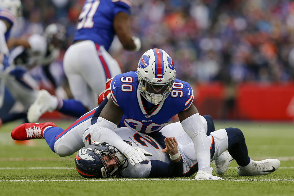 FILE - In this Nov. 24, 2019, file photo, Buffalo Bills defensive end Shaq Lawson (90) knocks Denver Broncos quarterback Brandon Allen (2) to the ground during the second quarter of an NFL football game in Orchard Park, N.Y. There won’t be any accusations of tanking this year by the Miami Dolphins, who added up to seven starters with a spending spree at the start of free agency. Lawson had a career-high 6 1/2 sacks last year for the Bills. (AP Photo/John Munson, File)