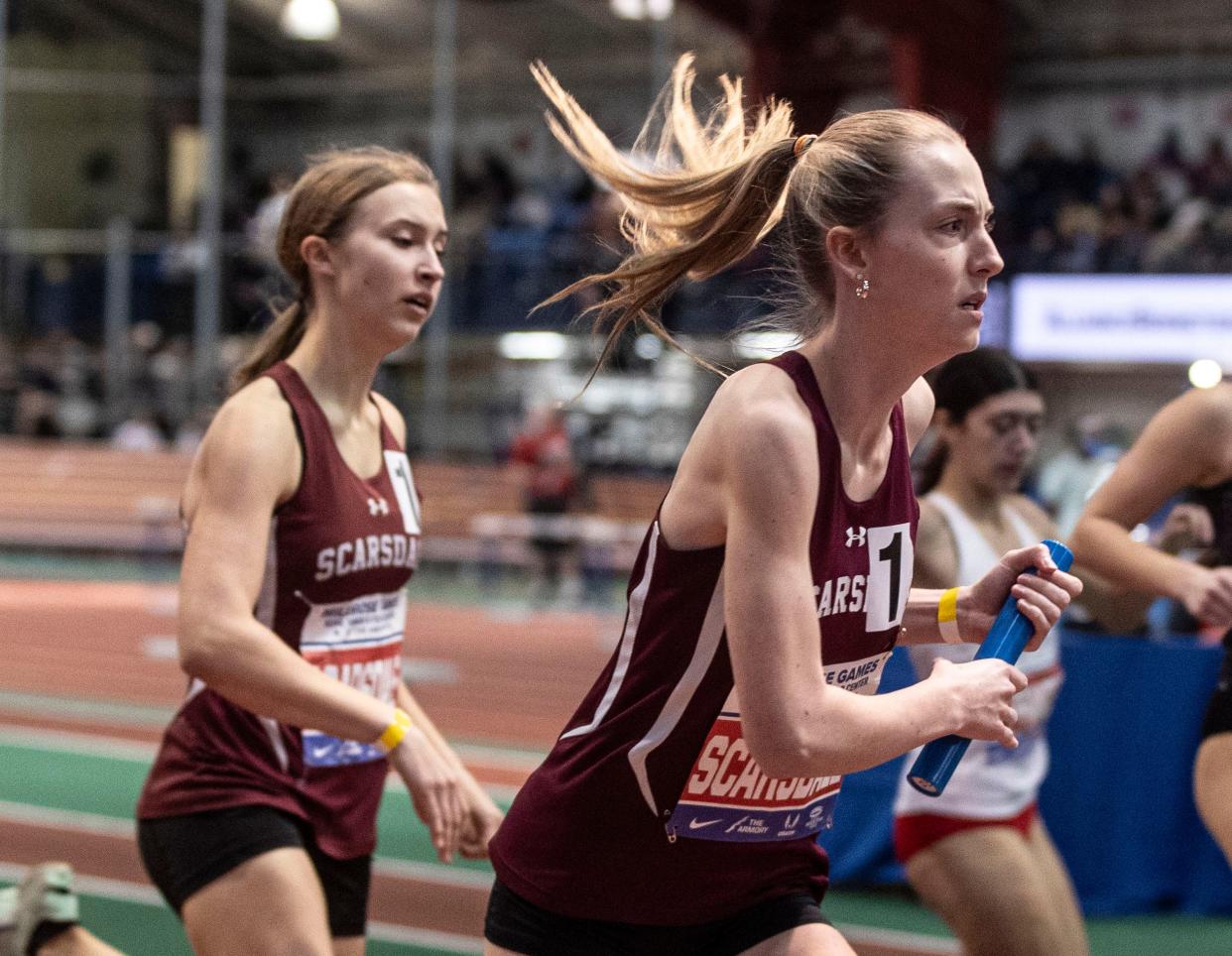 Feb 11, 2024; New York, New York, USA; Shannon Kelly takes the baton from Eva Gibney as Scarsdale competes in the Girls 4 x 400 meter relay during the Millrose Games at The Armory in New York City Feb. 11, 2024. Mandatory Credit: Seth Harrison-Westchester County Journal News