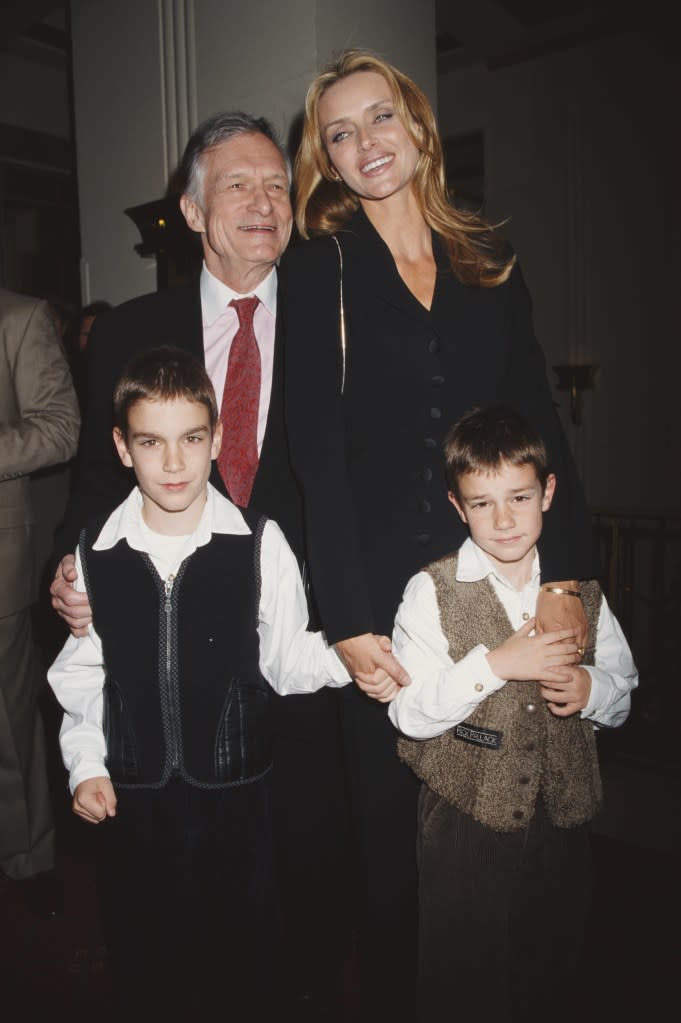 Marston (bottom left) as a young boy with brother Cooper, dad Hugh Hefner and mom Kimberly Conrad. Getty Images