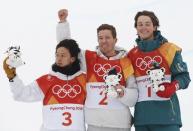 Snowboarding - Pyeongchang 2018 Winter Olympics - Men's Halfpipe Finals - Phoenix Snow Park – Pyeongchang, South Korea - February 14, 2018 - Gold medallist Shaun White of the U.S. is flanked by silver medallist Ayumu Hirano of Japan and bronze medallist Scotty James of Australia as they hold Soohorang Olympic mascots during the flower ceremony. REUTERS/Issei Kato