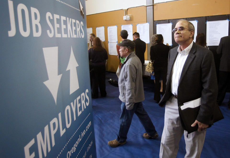 FILE - In this April 24, 2012, file photo, job seeker Alan Shull attends a job fair in Portland, Ore. The Labor Department said Friday, May 4, 2012, that the economy added just 115,000 jobs in April. U.S. employers pulled back on hiring for the second straight month, evidence of an economy still growing only sluggishly. The unemployment rate fell to 8.1 percent, but only because more people gave up looking for work. (AP Photo/Rick Bowmer, File)