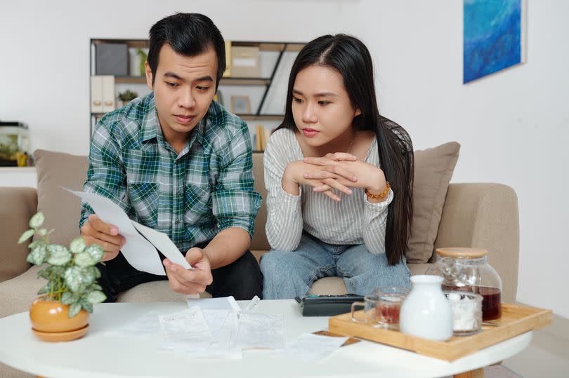 Couple looking at bills, stock money photo