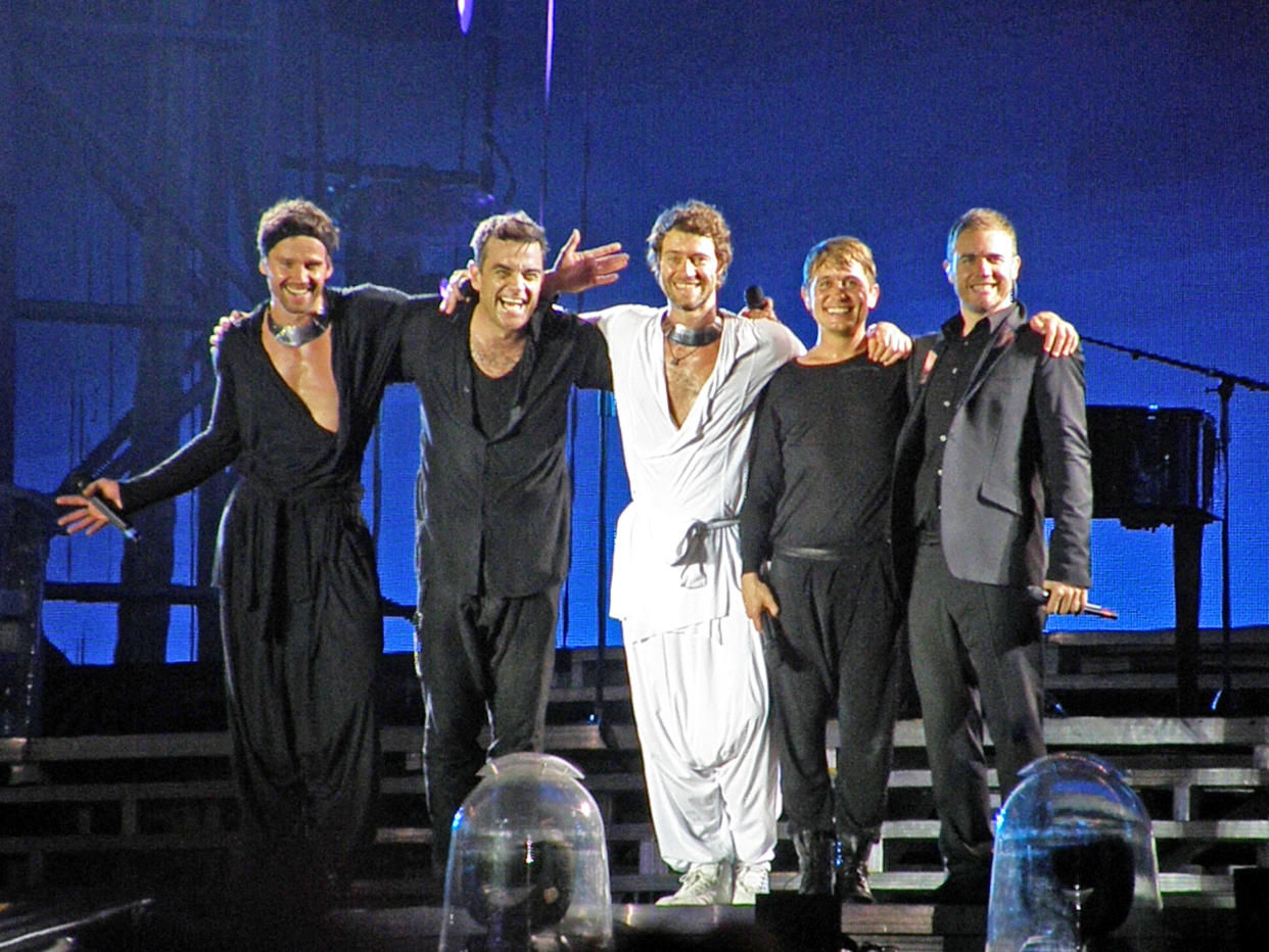 LONDON, UNITED KINGDOM - JULY 9: Jason Orange, Robbie Williams, Howard Donald, Mark Owen and Gary Barlow of Take That perform on stage on the band's 'Progress' tour at Wembley Stadium, on July 9th 2011 in London, England. (Photo by Pete Still/Redferns)