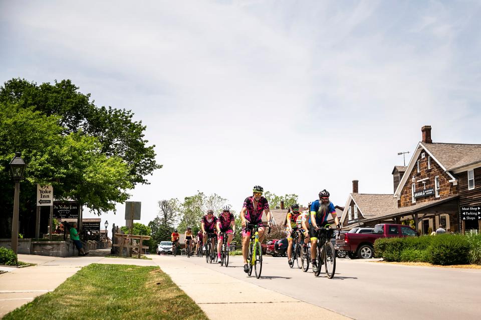 Riders roll into town during the RAGBRAI route inspection ride, Friday, June 9, 2023, in Amana, Iowa.
