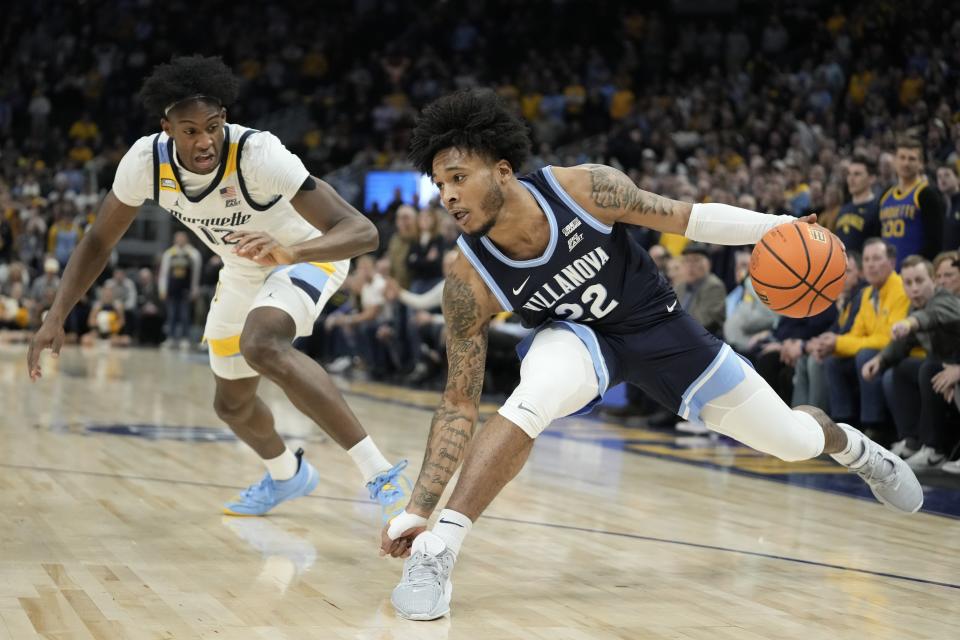 Villanova's Cam Whitmore tries to get past Marquette's Olivier-Maxence Prosper during the second half of an NCAA college basketball game Wednesday, Feb. 1, 2023, in Milwaukee. Marquette won 73-64. (AP Photo/Morry Gash)