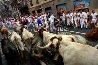 <p>Runners sprint ahead of bulls during the first running of the bulls at the San Fermin festival in Pamplona, northern Spain, July 7, 2017. (Susana Vera/Reuters) </p>