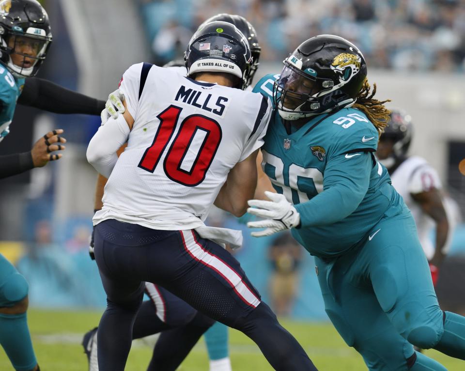 Jacksonville Jaguars defensive tackle Malcom Bryan (90) makes a sack on Houston Texans quarterback Davis Mills (10) during early second quarter action. The Jacksonville Jaguars hosted the Houston Texans at TIAA Bank Field in Jacksonville, Florida Sunday, December 19, 2021. [Bob Self/Florida Times-Union]