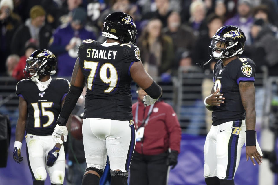 Baltimore Ravens quarterback Lamar Jackson (8) celebrates his touchdown run against the New England Patriots with offensive tackle Ronnie Stanley (79) during the first half of an NFL football game, Sunday, Nov. 3, 2019, in Baltimore. (AP Photo/Gail Burton)