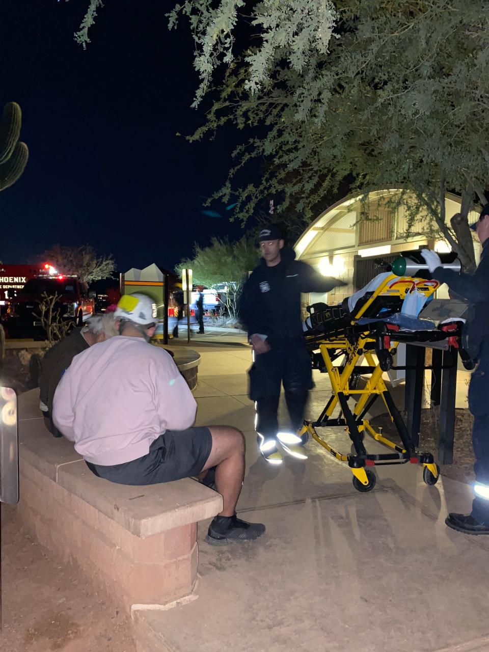 Phoenix Technical Rescue Teams staff assess an injured hiker after flying him in a helicopter off Camelback Mountain on Dec. 11, 2021.