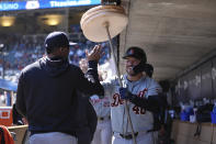 Detroit Tigers' Buddy Kennedy, right, celebrates in the dugout after hitting a two-run home run during the third inning of a baseball game against the Minnesota Twins, Sunday, April 21, 2024, in Minneapolis. (AP Photo/Abbie Parr)