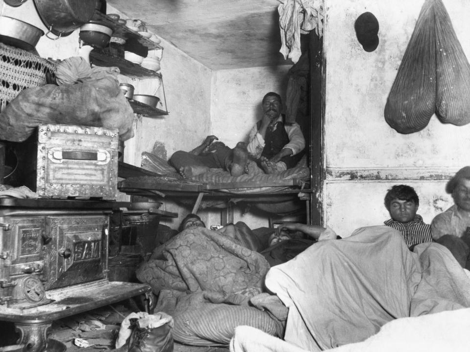 Immigrants are photographed in a shelter in a Bayard Street tenement.