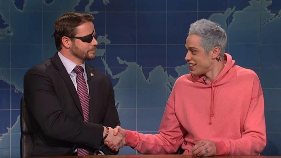 Comedian Pete Davidson, right, shakes hands with Dan Crenshaw, a former Navy SEAL and Texas Republican newly elected to Congress.