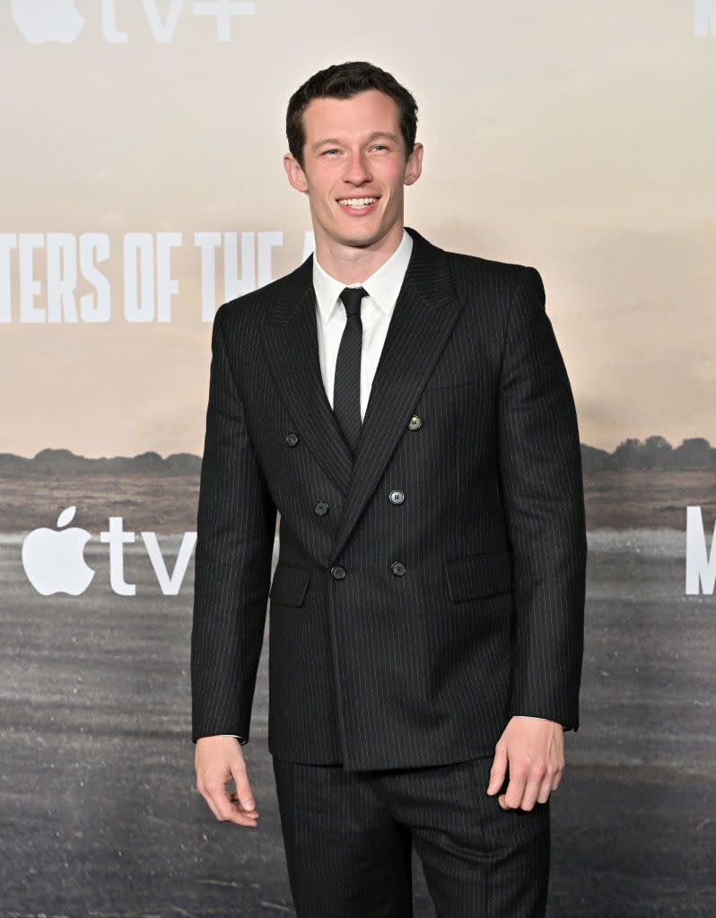 callum turner poses at premiere