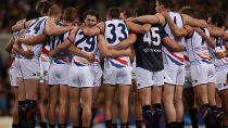 The players in a pre-match huddle.