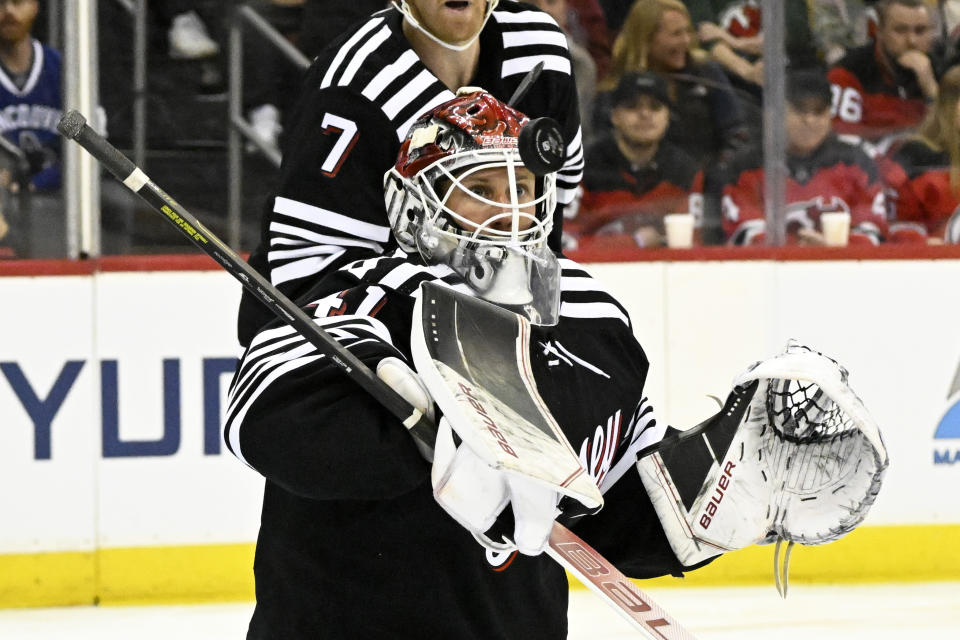 New Jersey Devils goaltender Vitek Vanecek (41) watches the puck as he makes a save during the first period of an NHL hockey game against the Vancouver Canucks, Monday, Feb. 6, 2023, in Newark, N.J. (AP Photo/Bill Kostroun)