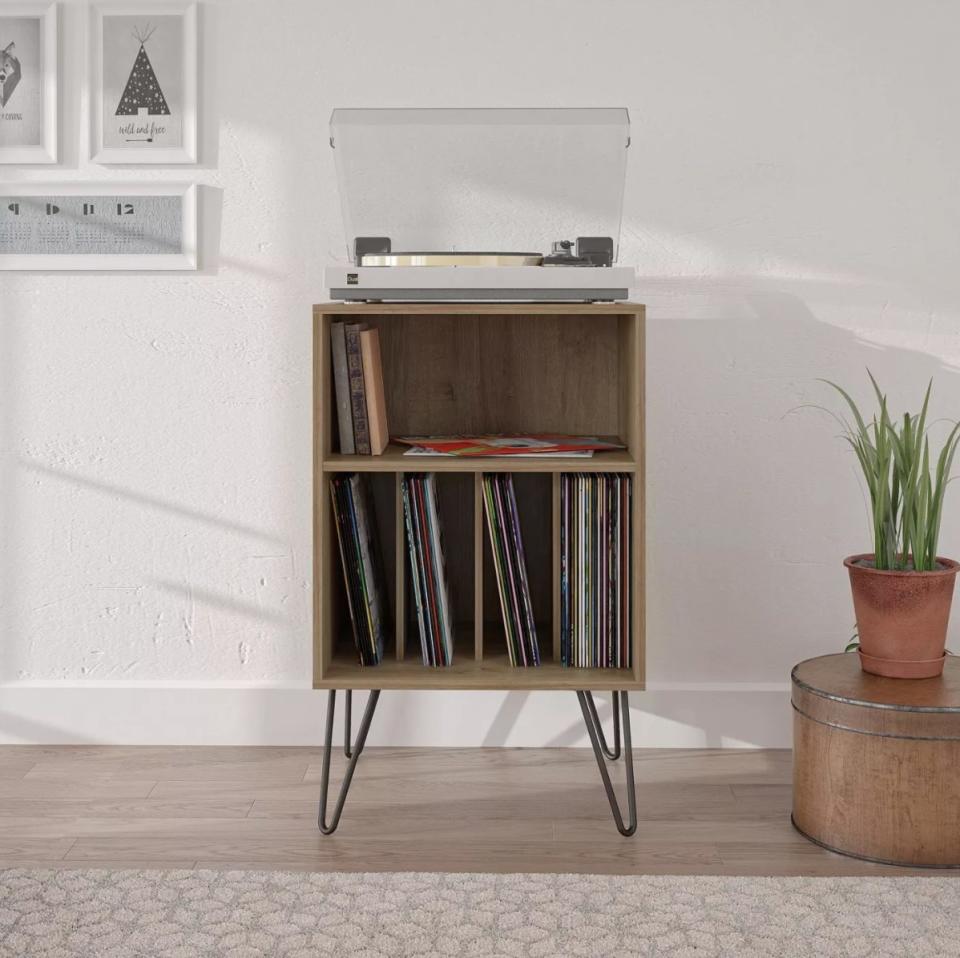 The reclaimed oak vinyl record stand holding a record player and tens of records