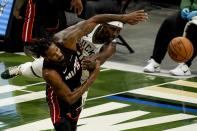 Miami Heat's Trevor Ariza and Milwaukee Bucks' Jrue Holiday go after a loose ball during the first half of an NBA basketball game Saturday, May 15, 2021, in Milwaukee. (AP Photo/Morry Gash)