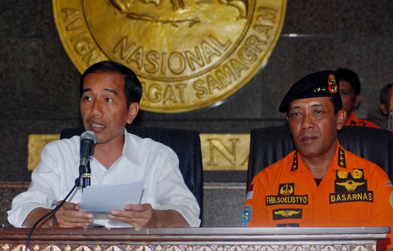 Indonesia's President Joko Widodo (left) and Soelistyo -- the head of Indonesia's National Search and Rescue Agency -- speaks to journalists about the missing AirAsia flight QZ8501 at a press conference in Jakarta, on December 29, 2014