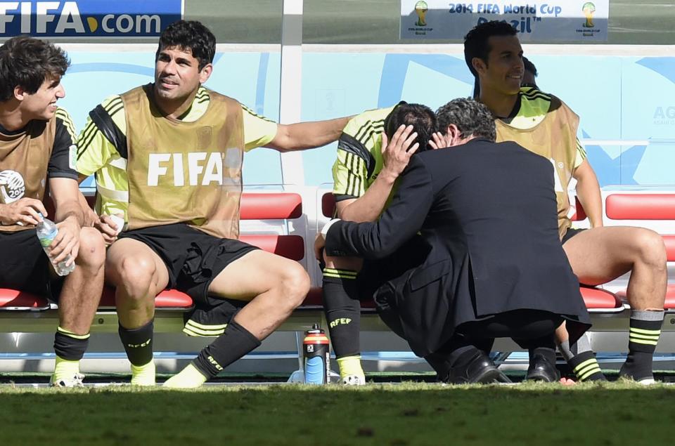 Spain&#39;s forward David Villa is comforted by Diego Costa after he was substituted during the match between Australia and Spain at the Baixada Arena in Curitiba during the World Cup on June 23, 2014 (AFP Photo/Juan Barreto)