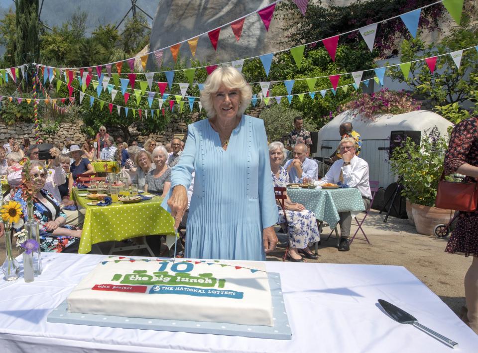 TOPSHOT - Britain's Camilla, Duchess of Cornwall poses for a photograph as she cuts a birthday cake as she attends the tenth anniversary celebration of The Big Lunch initiative at the Eden Project in south west England on July 15, 2019. - The Big Lunch is Edens biggest outreach project, since 2009 it has brought people together with their neighbours for a few hours of community, friendship and fun. (Photo by ARTHUR EDWARDS / POOL / AFP) (Photo by ARTHUR EDWARDS/POOL/AFP via Getty Images)