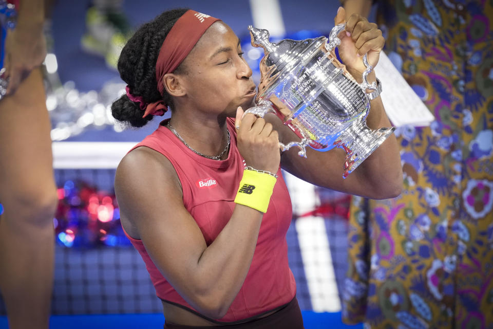 Coco Gauff, of the United States, poses for photographs after defeating Aryna Sabalenka, of Belarus, at the women's singles final of the U.S. Open tennis championships, Saturday, Sept. 9, 2023, in New York. (AP Photo/John Minchillo)