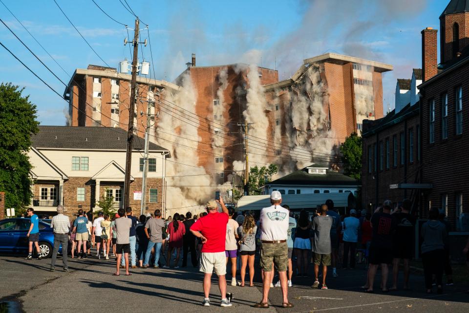 Onlookers watch from Seventh Avenue as Julia Tutwiler Hall collapses during the dorm’s controlled implosion, Monday July 4, 2022.