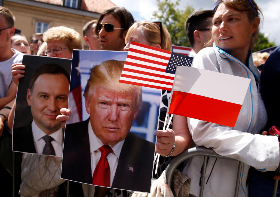 People hold portraits of Trump and Duda.&nbsp;