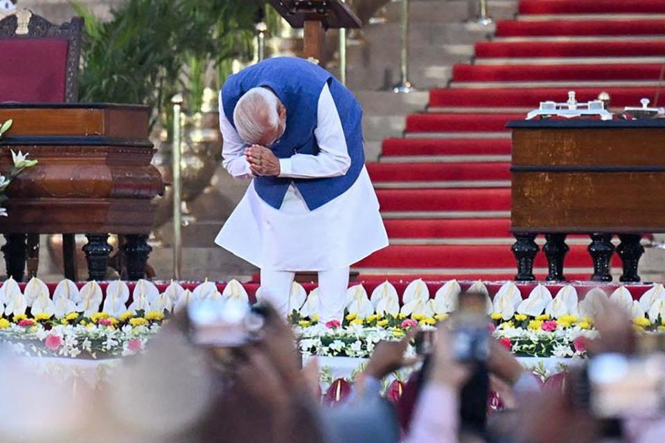 India's newly sworn-in Prime Minister Narendra Modi gestures to the gathering after taking the oath of office during the oath-taking ceremony at presidential palace Rashtrapati Bhavan in New Delhi on June 9, 2024. India's Prime Minister Narendra Modi was sworn in on June 9, for a third term after worse-than-expected election results left him reliant on coalition partners to govern. (Photo by Money SHARMA / AFP) (Photo by MONEY SHARMA/AFP via Getty Images)