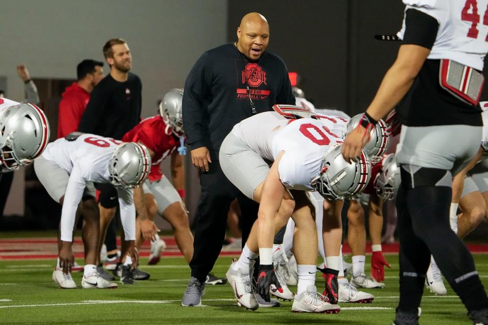 Ohio State Buckeyes safeties coach Perry Eliano guides players through warm ups prior to a spring football practice at the Woody Hayes Athletics Center in Columbus on March 22, 2022.
