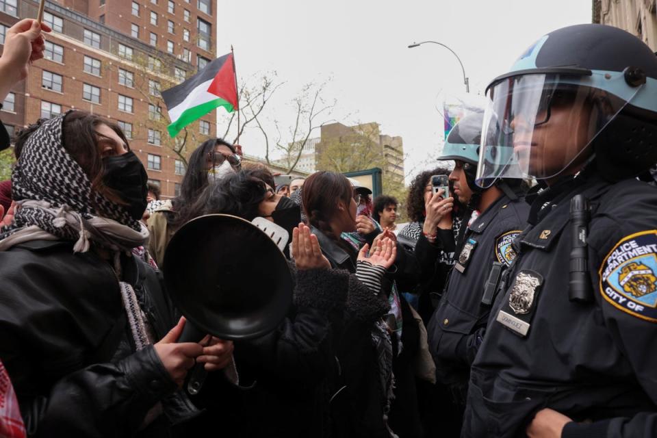 Police officers stand guard as demonstrators protest in solidarity with Pro-Palestinian organizers on the Columbia University campus (REUTERS)