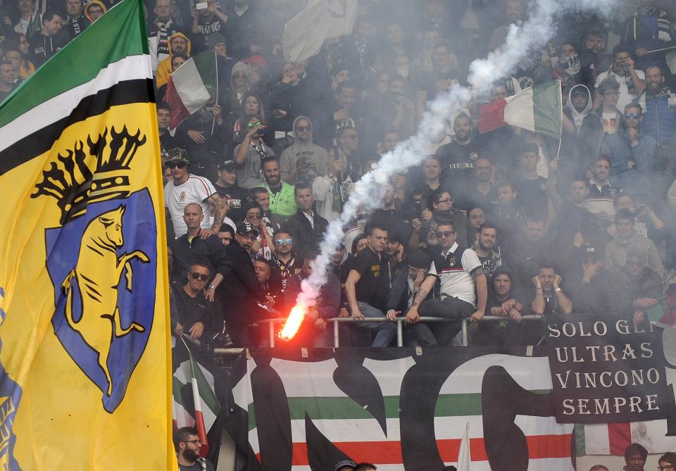 Juventus' supporters look on as a flare is thrown during their Italian Serie A soccer match against Torino in Turin