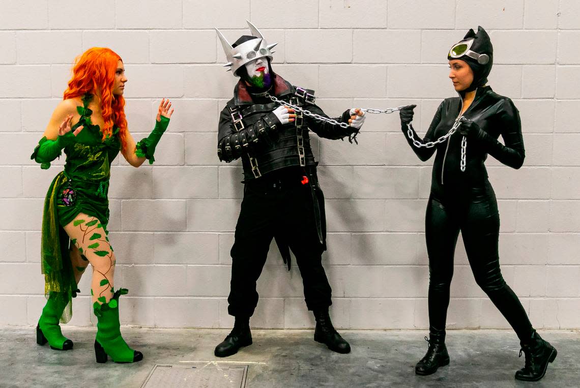 Cosplayers Sophia Ware as Poison Ivy, Samuel Adler as the Batman Who Laughs, and Samantha Ware as Catwoman, at Florida Supercon.