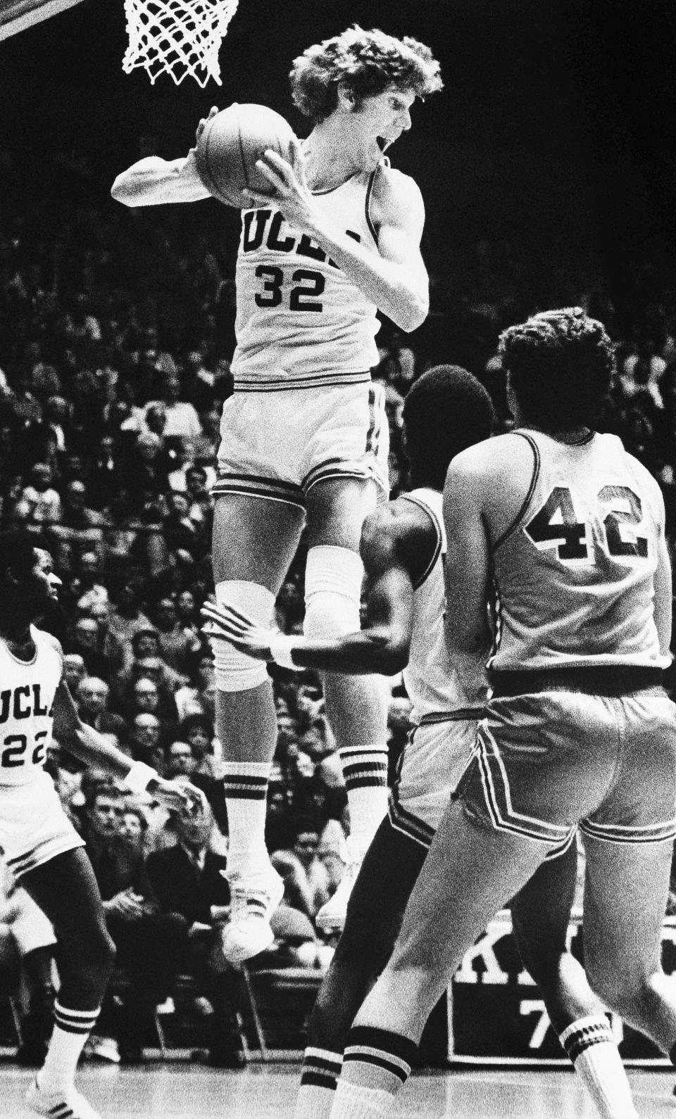 FILE - UCLA's Bill Walton grabs a rebound against the University of San Francisco during the final game at the NCAA college basketball West Regionals in San Francisco, Saturday, March 20, 1973. (AP Photo/David F. Smith, File)