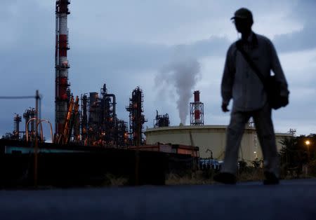 A man walks past a factory at the Keihin industrial zone in Kawasaki, south of Tokyo, Japan, August 18, 2016. Picture taken on August 18, 2016. REUTERS/Kim Kyung-Hoon