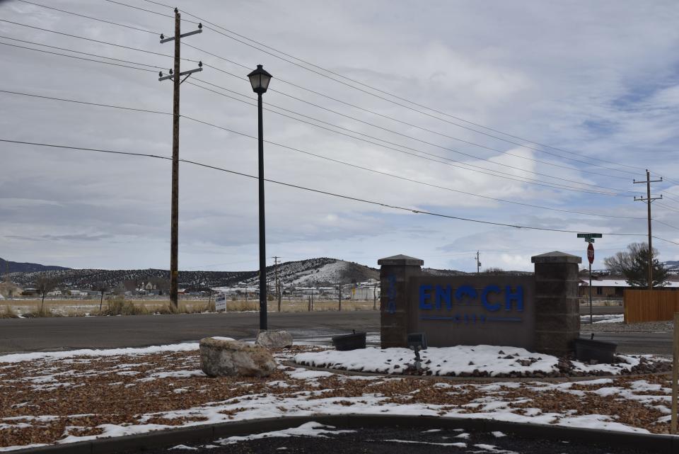 Snow sits atop a sign outside the offices of Enoch City. The small community, with a population of about 7,500, was reeling the week after a resident apparently shot and killed his entire family and them himself on Wednesday, leaving eight people dead, including the man's five children.