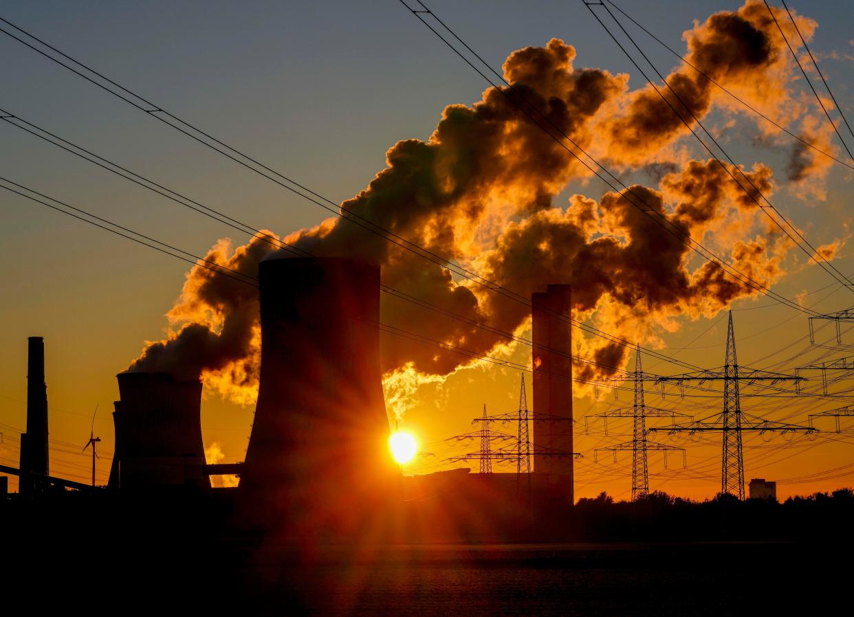 Steam comes out of the chimneys of a coal-fired power station in Niederaussem, Germany, Sunday, Oct. 24, 2021.