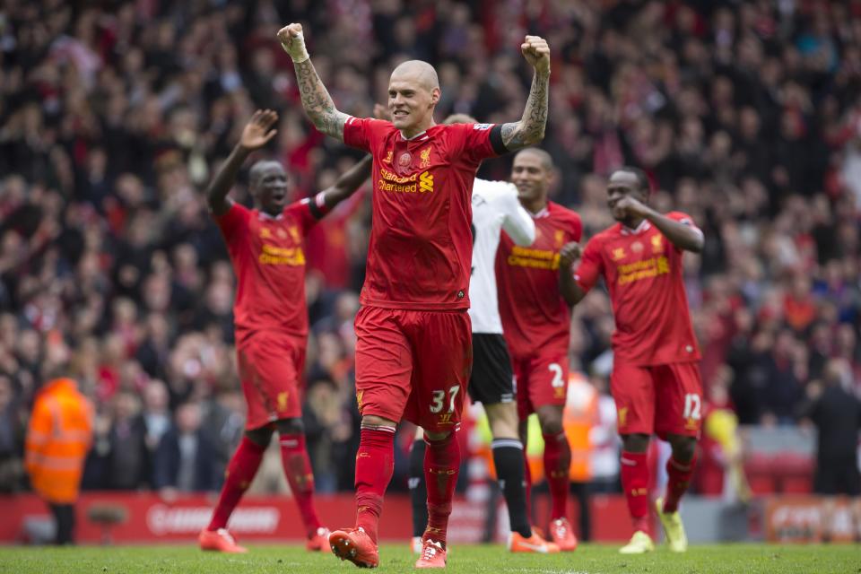 Liverpool's Martin Skrtel, centre, celebrates with teammates as his team beat Manchester City 3-2 during their English Premier League soccer match at Anfield Stadium, Liverpool, England, Sunday April 13, 2014. (AP Photo/Jon Super)