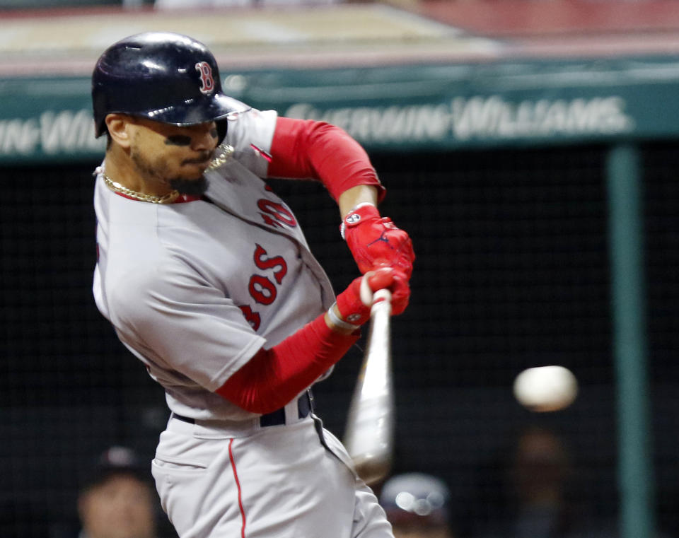 File-This Sept. 23, 2018, file photo shows Boston Red Sox's Mookie Betts hitting a double in the seventh inning of a baseball game against the Cleveland Indians, in Cleveland. Betts won this year’s AL batting title at .346 and with (32) homers and 30 (stolen bases) became the first player to lead either league in batting as part of a 30-30 season. (AP Photo/Tom E. Puskar, File)