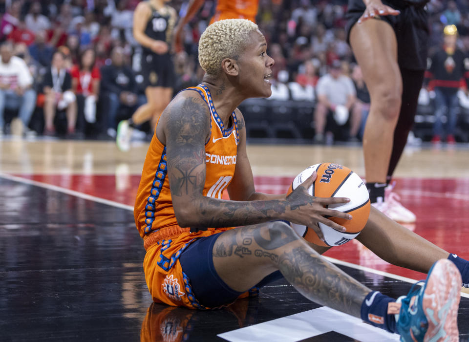 Connecticut Sun guard Courtney Williams (10) complains about a foul call on Las Vegas Aces forward A'ja Wilson (22) during the first half in Game 1 of a WNBA basketball final playoff series Sunday, Sept. 11, 2022, in Las Vegas. (AP Photo/L.E. Baskow)