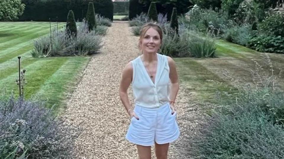 Geri Horner posing in white shorts at amazing country home