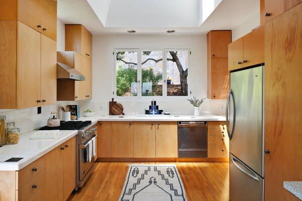 An expansive skylight allows ample sunshine to sweep across the remodeled kitchen.
