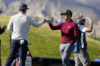Patrick Cantlay, right, bumps fists with Andrew Putman before teeing off on the first hole during the final round of The American Express golf tournament on the Pete Dye Stadium Course at PGA West, Sunday, Jan. 24, 2021, in La Quinta, Calif. (AP Photo/Marcio Jose Sanchez)