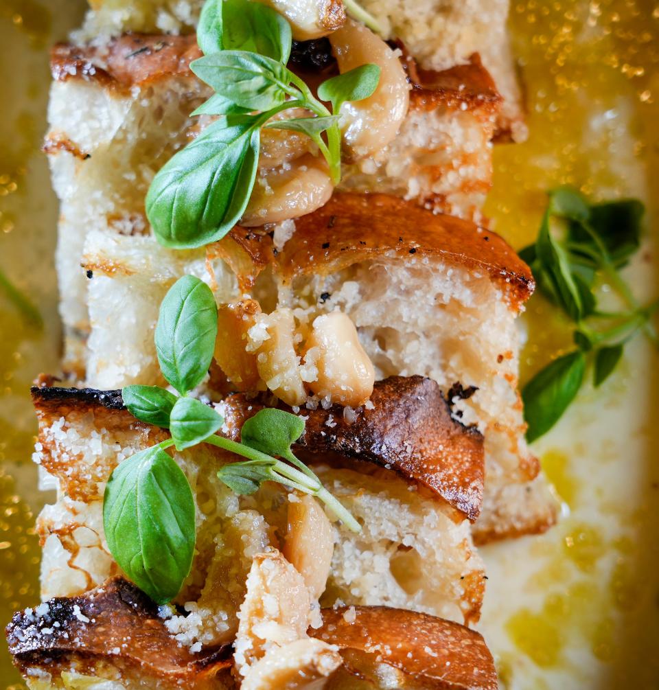 The Roasted Garlic Focaccia with mascarpone fontina fonduta and garlic confit, pictured on Oct. 8, 2023, is one of three "pane" offerings at II Cervo restaurant on the ninth floor of the Trade Hotel in Milwaukee.