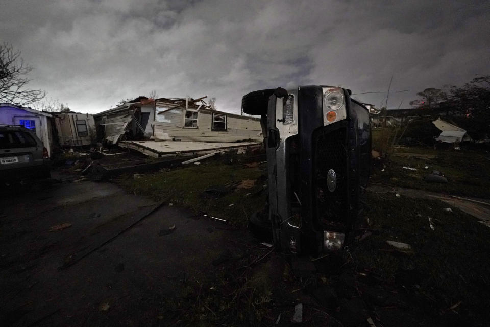 A truck lies on this side in front of a destroyed home after a tornado swept through the area in Arabi, La., Tuesday, March 22, 2022. A tornado tore through parts of New Orleans and its suburbs Tuesday night, ripping down power lines and scattering debris in a part of the city that had been heavily damaged by Hurricane Katrina 17 years ago. (AP Photo/Gerald Herbert)