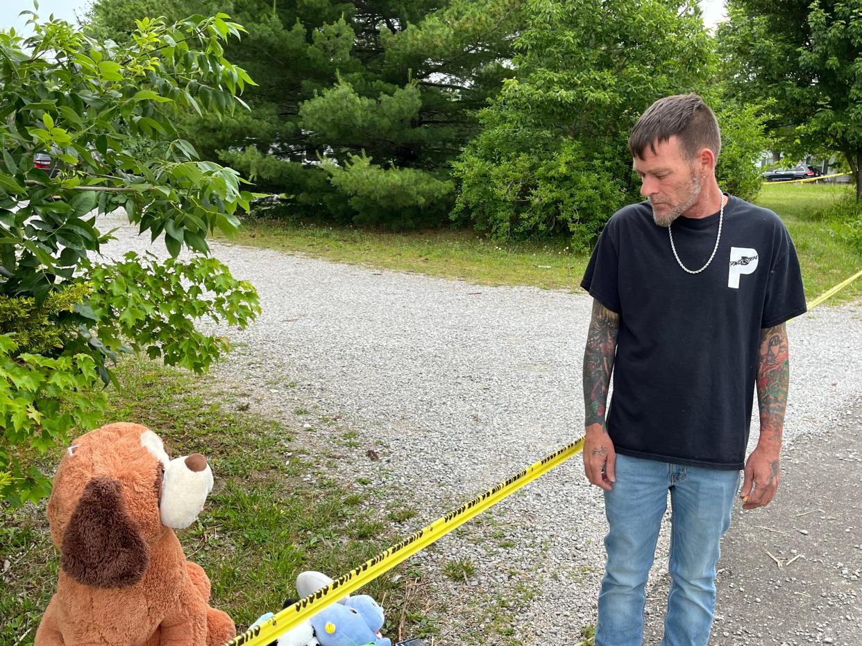 Richard Kincannon, 49, looks at the memorial made at the home of three boys killed in a shooting at their Monroe Township home.