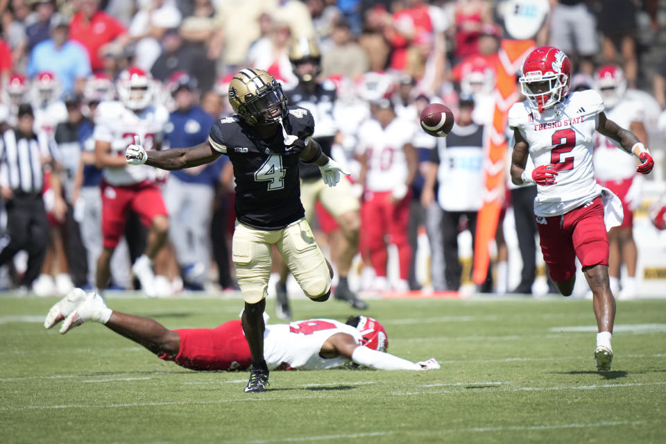 An incomplete pass falls between Purdue wide receiver Deion Burks (4) and Fresno State defensive back Carlton Johnson (2) during the second half of an NCAA college football game in West Lafayette, Ind., Saturday, Sept. 2, 2023. Fresno State won 38-35. (AP Photo/AJ Mast)